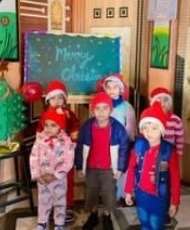 Children in Santa hats at the school's Christmas celebration